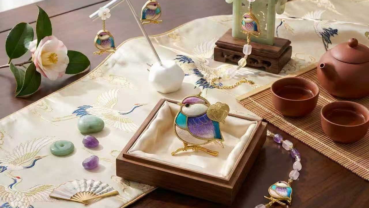 Decorative bird figurine on a wooden stand with a teapot and tea cups in the background.